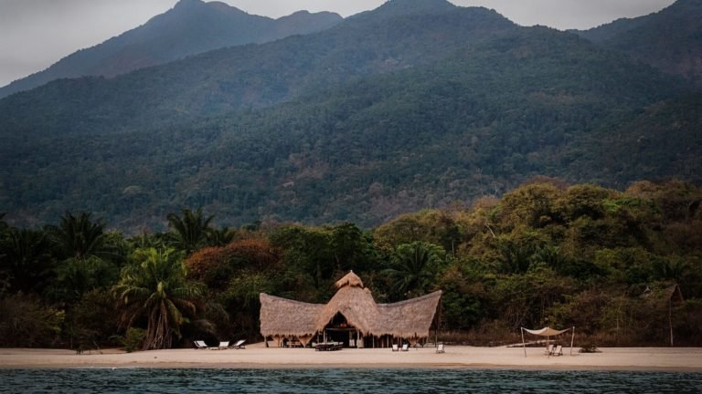 Aerial view of Mahale Mountains National Park surrounded by lush greenery and bordered by Lake Tanganyika in Tanzania
