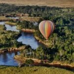 Hot air balloon floating above the vast plains of Serengeti National Park